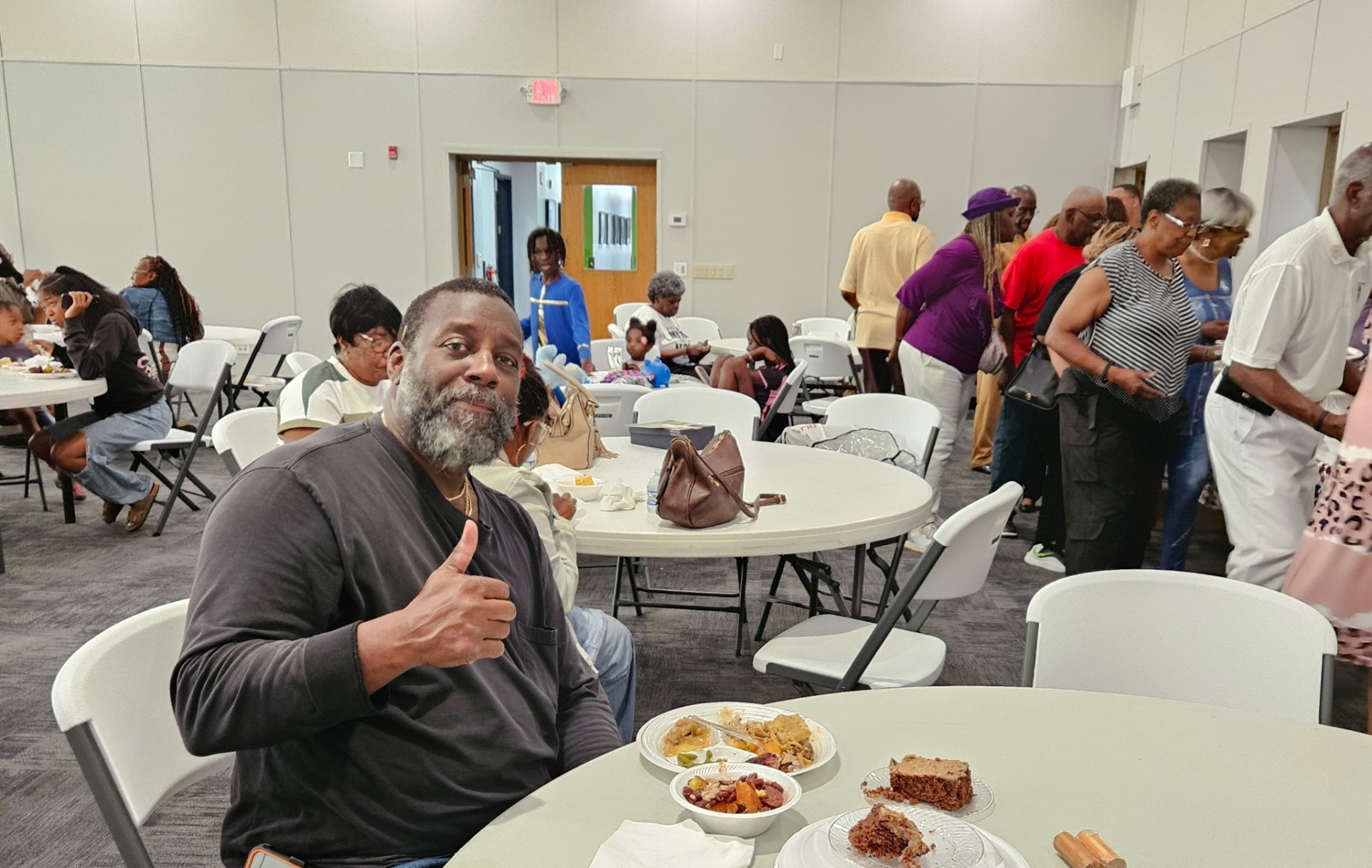 Member giving a thumbs up during the fellowship dinner