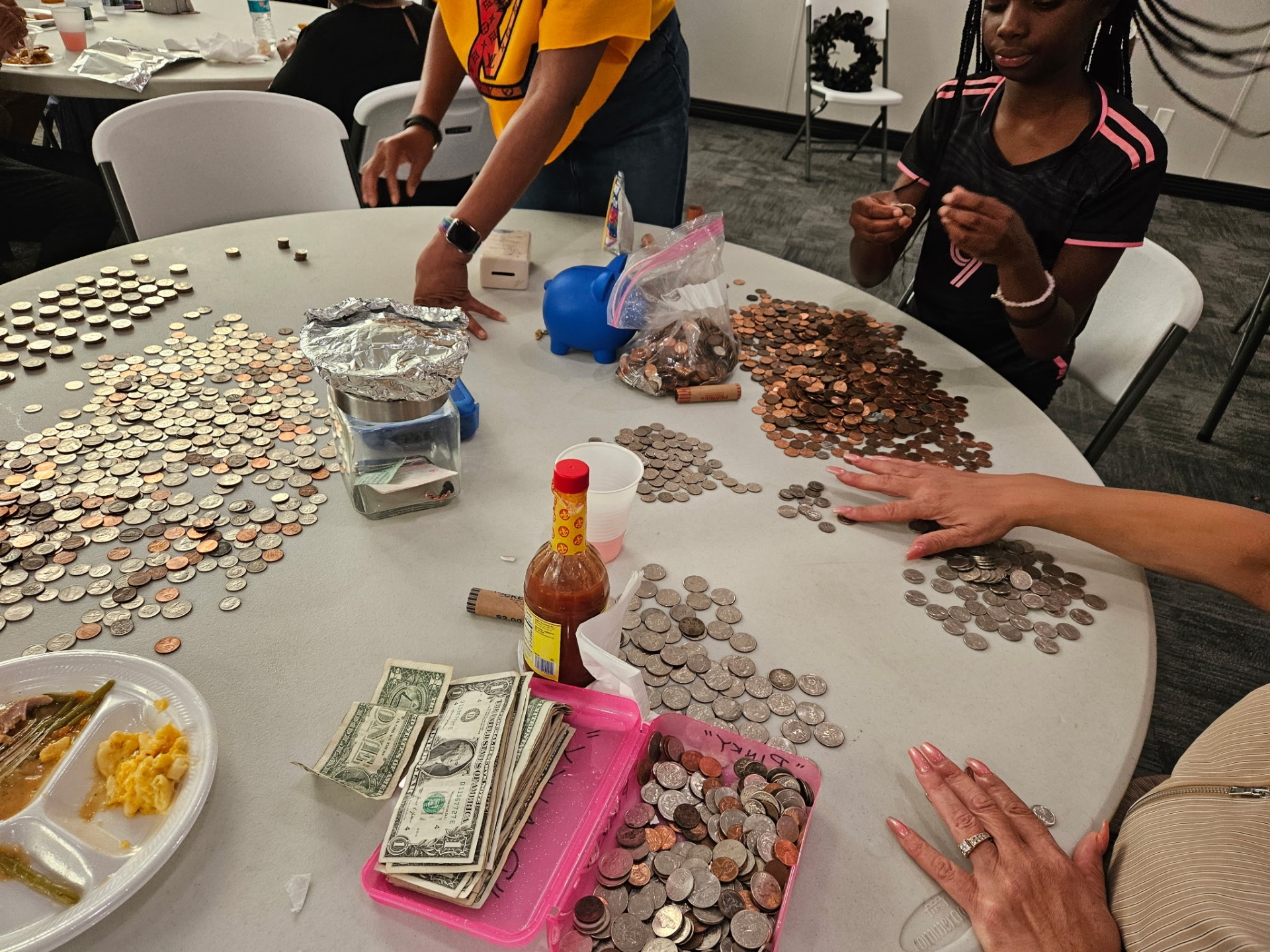 Members counting coins and offerings collected for the fundraiser